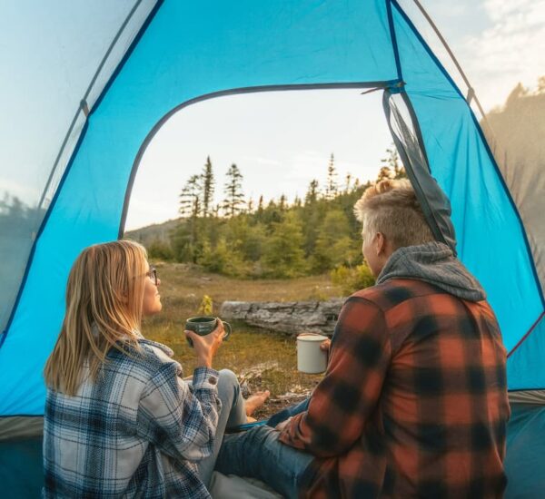 a couple in a tent at a camping